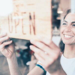 Woman smiling opening her store