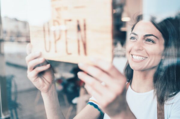 Woman smiling opening her store